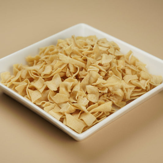 White square plate with papri gathiya on a beige background bombay nimco