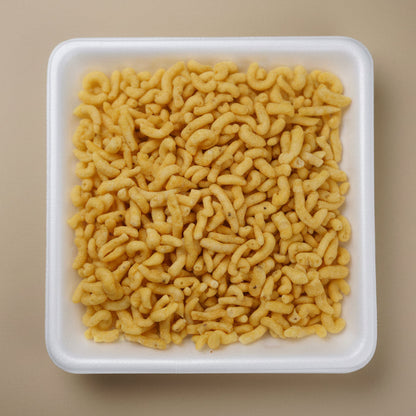 Square white container filled with Bareek Gathiya crafted by Bombay Nimco